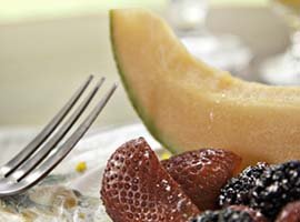 fresh berries and a wedge of cantaloupe