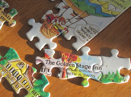 puzzle pieces partially connected with the words The Golden Stage Inn on one area