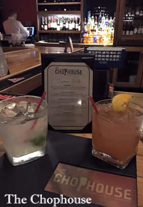 cocktails on bar counter with drink menu